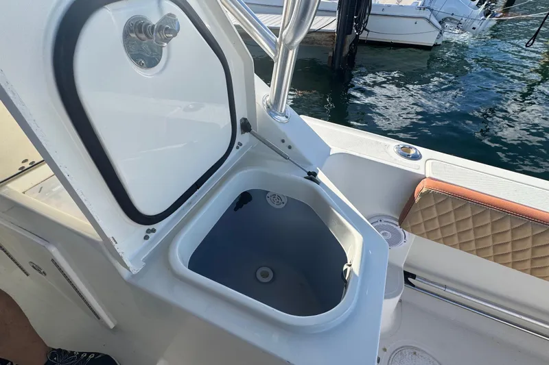  Yacht Photos Pics Open storage compartment on 2011 Hydra-Sports 3000 VX boat, docked by the water.