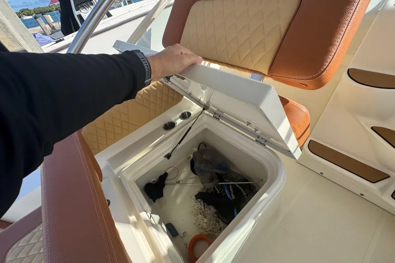  Yacht Photos Pics 2011 Hydra-Sports 3000 VX boat storage compartment with fishing gear and accessories.