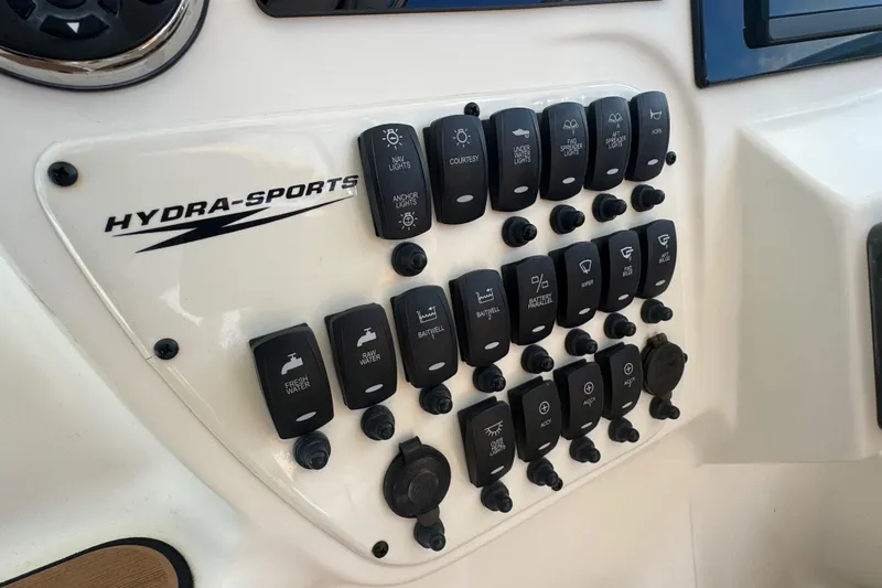  Yacht Photos Pics Control panel of a 2011 Hydra-Sports 3000 VX boat with labeled switches.