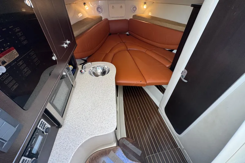  Yacht Photos Pics 2011 Hydra-Sports 3000 VX cabin interior with kitchenette and seating area.