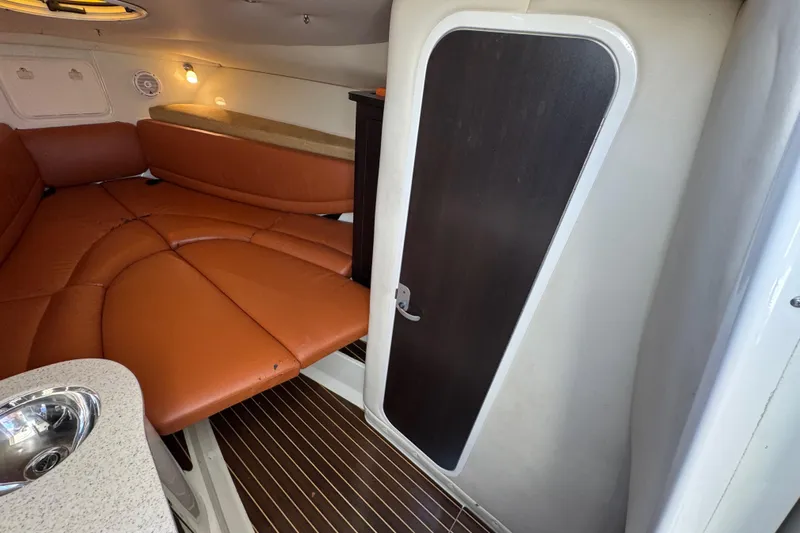  Yacht Photos Pics 2011 Hydra-Sports 3000 VX cabin interior with brown seating and wooden flooring.