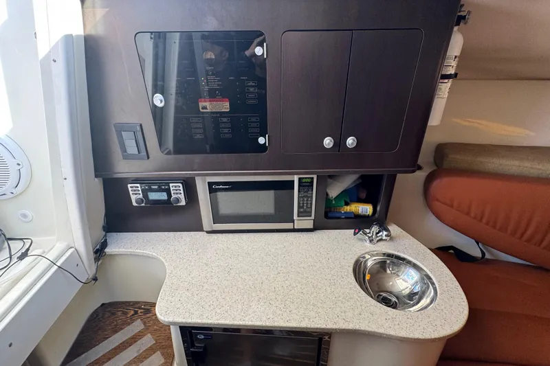  Yacht Photos Pics 2011 Hydra-Sports 3000 VX cabin interior with microwave, sink, and control panel.