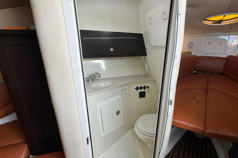  Yacht Photos Pics 2011 Hydra-Sports 3000 VX boat interior with compact bathroom and seating area.