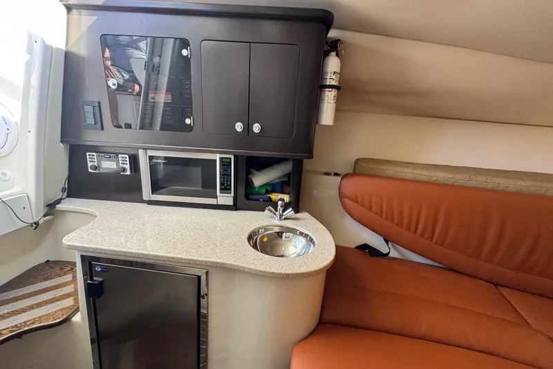  Yacht Photos Pics 2011 Hydra-Sports 3000 VX cabin with kitchenette, microwave, sink, and seating area.