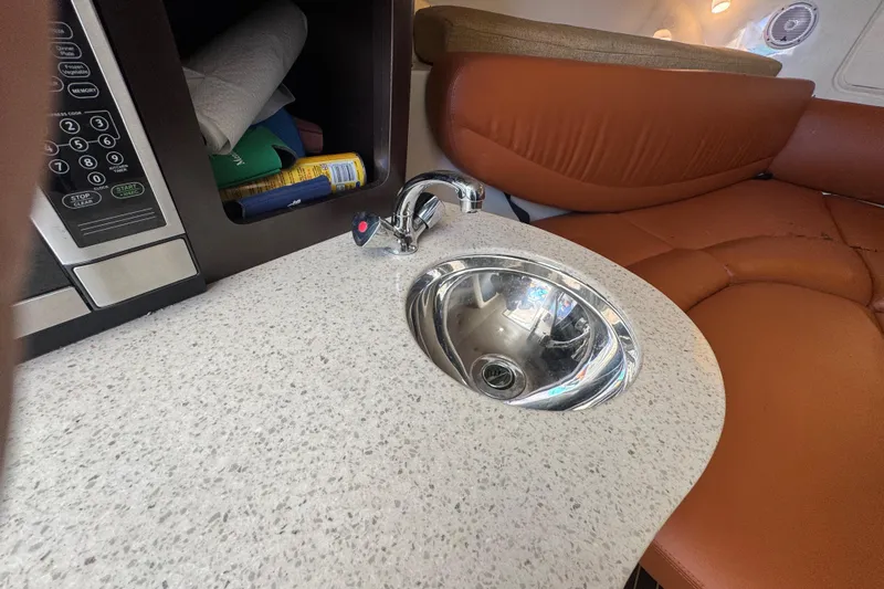  Yacht Photos Pics 2011 Hydra-Sports 3000 VX interior with sink, microwave, and leather seating.