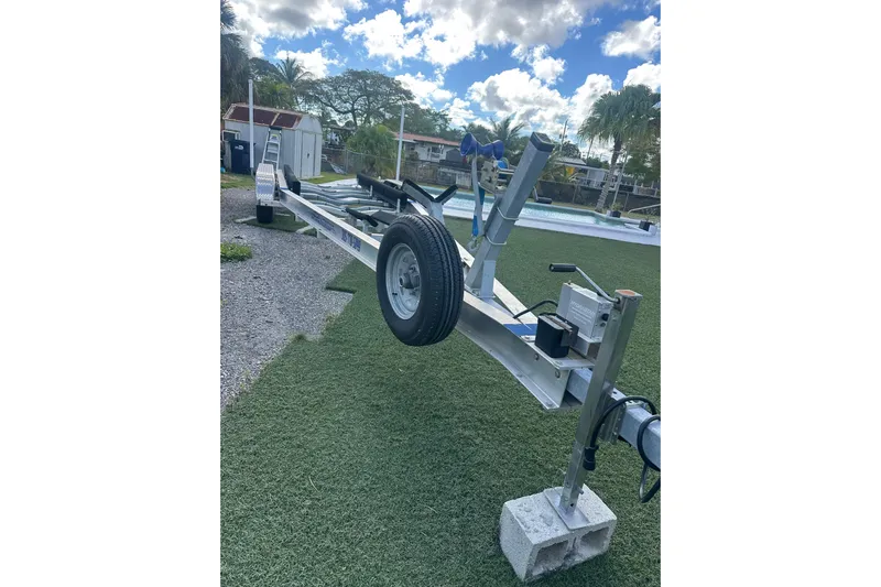  Yacht Photos Pics Trailer for 2011 Hydra-Sports 3000 VX boat on grass, under a cloudy sky.