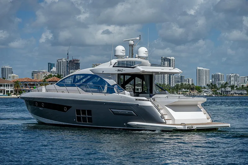  Yacht Photos Pics 2022 Azimut S6 yacht cruising on water with city skyline in background.