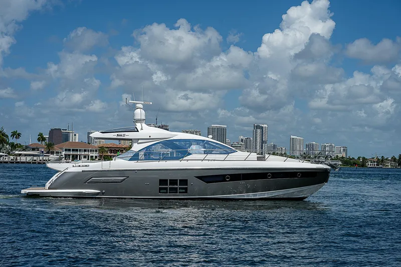  Yacht Photos Pics 2022 Azimut S6 yacht cruising on a sunny day with city skyline in the background.