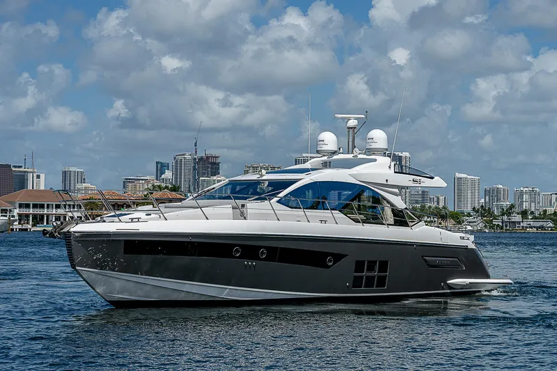  Yacht Photos Pics 2022 Azimut S6 yacht cruising on a sunny day with city skyline backdrop.