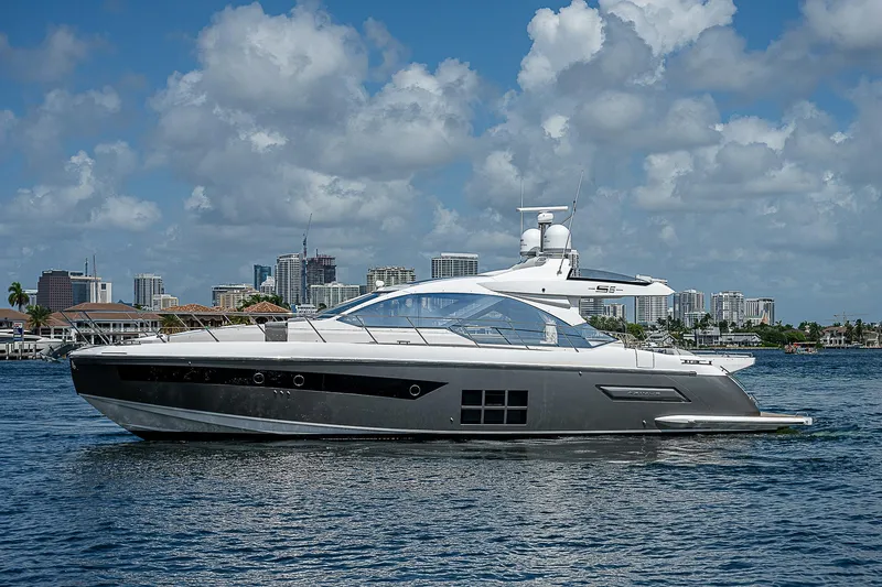  Yacht Photos Pics 2022 Azimut S6 yacht cruising on a sunny day with city skyline backdrop.
