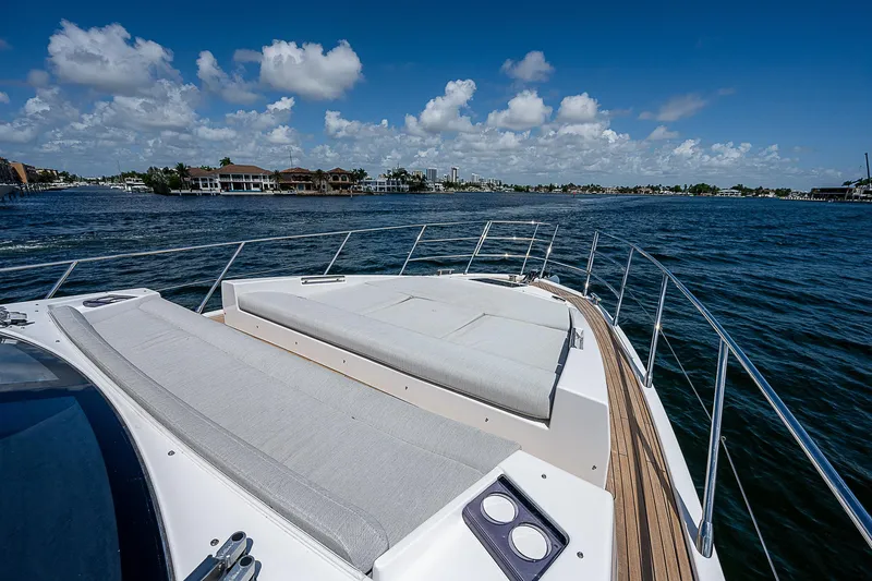  Yacht Photos Pics 2022 Azimut S6 yacht deck with sunbed, overlooking serene blue waters and clear sky.