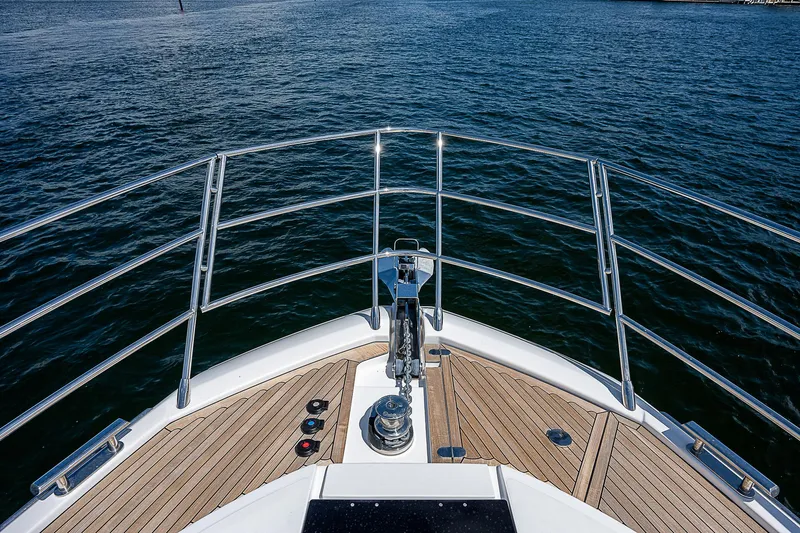  Yacht Photos Pics Bow view of 2022 Azimut S6 yacht with teak deck and stainless steel railings.