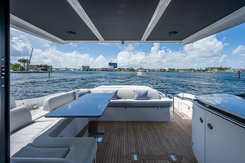  Yacht Photos Pics Luxurious 2022 Azimut S6 yacht deck with seating, table, and ocean view.