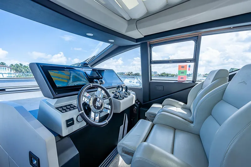  Yacht Photos Pics 2022 Azimut S6 yacht cockpit with modern steering and dual leather seats.