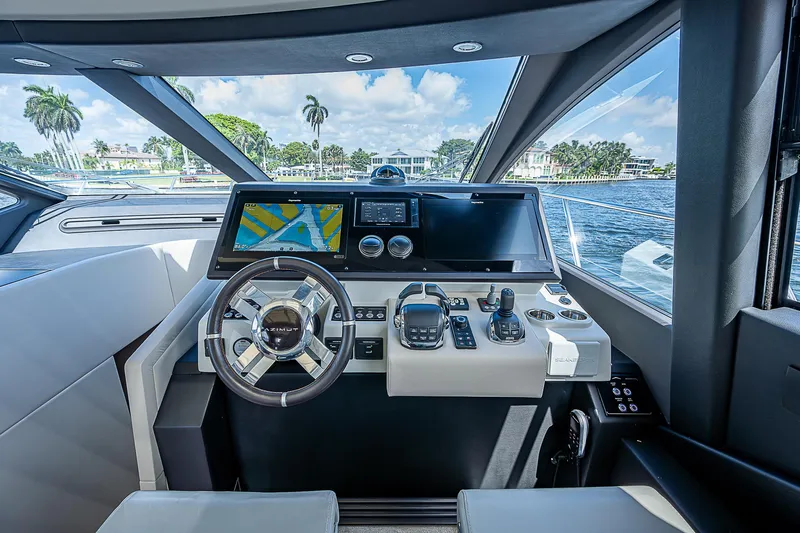  Yacht Photos Pics Cockpit of 2022 Azimut S6 yacht with modern navigation controls and scenic waterfront view.