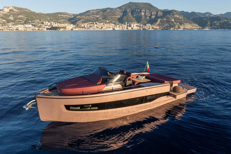  Yacht Photos Pics 2025 Cranchi A32 Luxury Tender yacht on serene blue waters with scenic mountain backdrop.