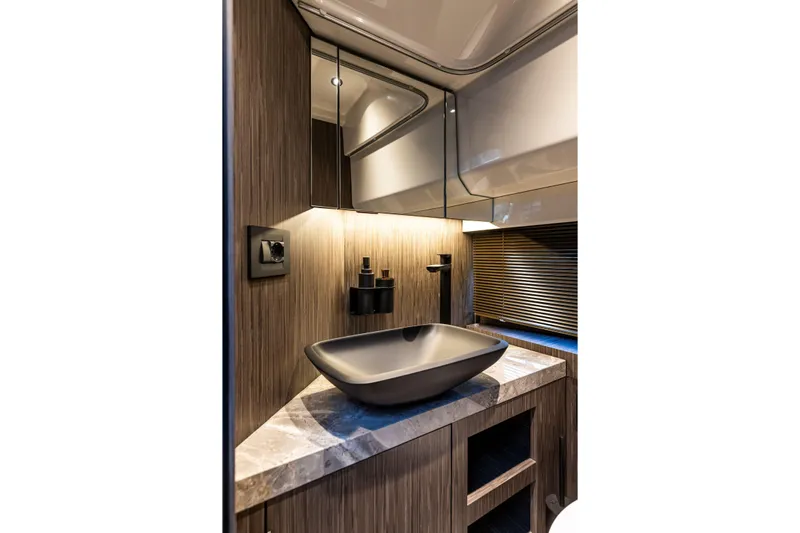  Yacht Photos Pics Luxurious bathroom interior of 2025 Cranchi A32 Luxury Tender with modern sink and wood accents.
