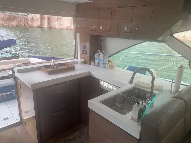  Yacht Photos Pics Interior of 2018 Cruisers Yachts 54 Cantius with modern kitchen and scenic water view.