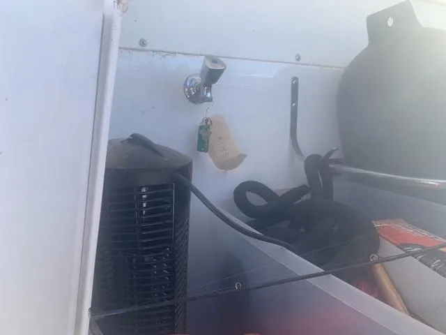  Yacht Photos Pics Storage compartment of a 2018 Cruisers Yachts 54 Cantius with various boating equipment.