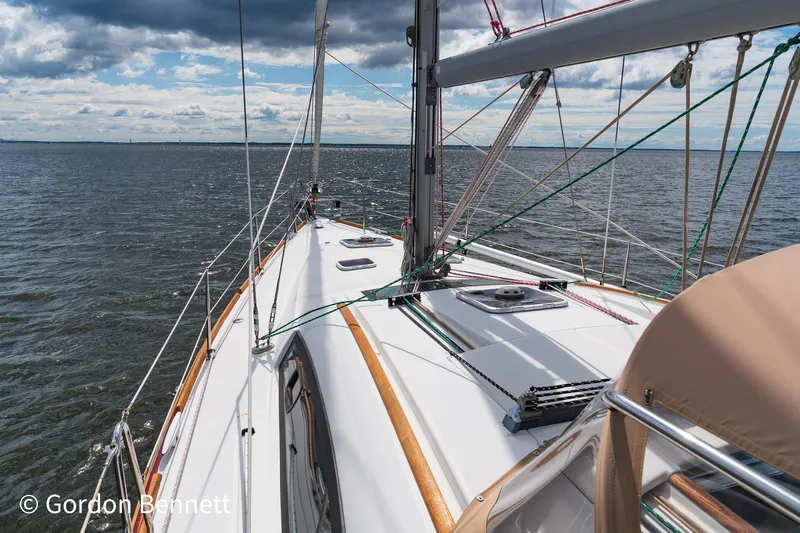 Queens Share Yacht Photos Pics Sailing on a 2008 Beneteau Oceanis 43 yacht, open sea view, cloudy sky.