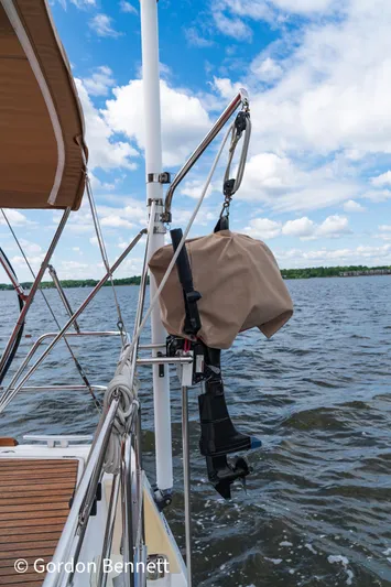 Queens Share Yacht Photos Pics Beneteau Oceanis 43 sailboat, 2008 model, with covered equipment, sailing on a calm lake.