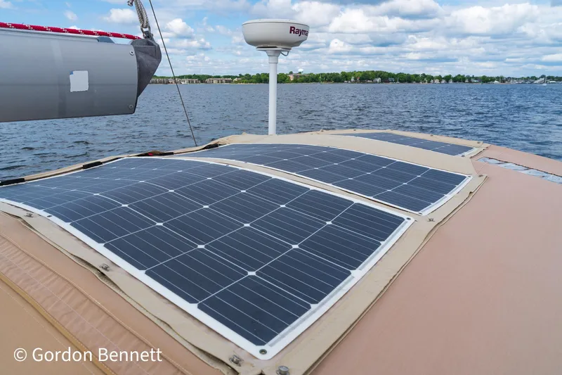 Queens Share Yacht Photos Pics Solar panels on a 2008 Beneteau Oceanis 43 sailboat under a cloudy sky.