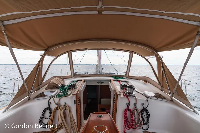 Queens Share Yacht Photos Pics Beneteau Oceanis 43 sailboat cockpit with canopy, ropes, and ocean view, 2008 model.