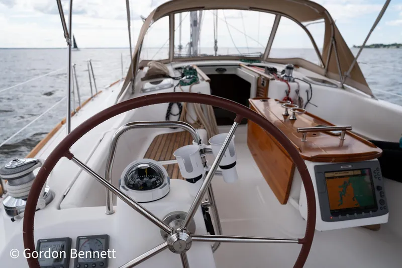 Queens Share Yacht Photos Pics Cockpit of 2008 Beneteau Oceanis 43 sailboat with steering wheel and navigation equipment.