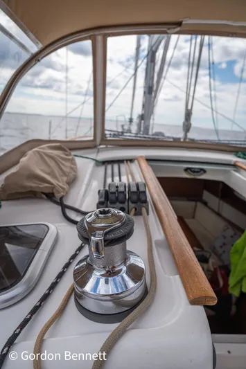 Queens Share Yacht Photos Pics 2008 Beneteau Oceanis 43 sailboat deck with winch and ropes, under a cloudy sky.