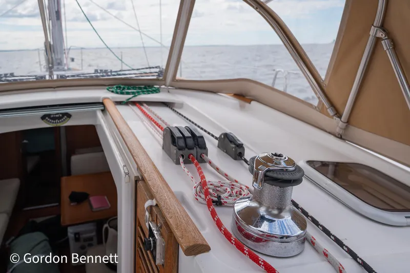 Queens Share Yacht Photos Pics Beneteau Oceanis 43 sailboat deck, 2008 model, featuring winch and ropes, sailing on open sea.