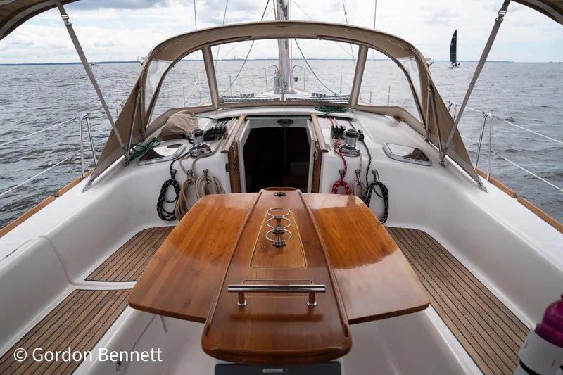 Queens Share Yacht Photos Pics 2008 Beneteau Oceanis 43 sailboat cockpit with wooden table, open sea view.