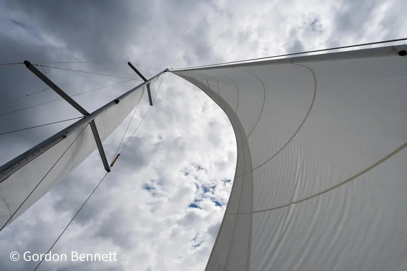 Queens Share Yacht Photos Pics Sail of 2008 Beneteau Oceanis 43 yacht against cloudy sky.