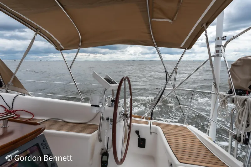 Queens Share Yacht Photos Pics Beneteau Oceanis 43 sailboat cockpit view, 2008 model, with ocean backdrop.