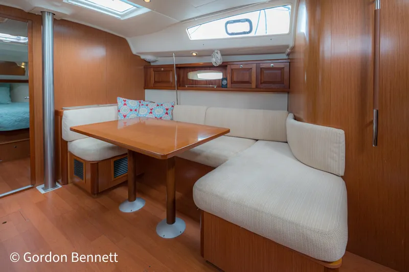 Queens Share Yacht Photos Pics Interior of 2008 Beneteau Oceanis 43 yacht with cozy seating and wooden table.
