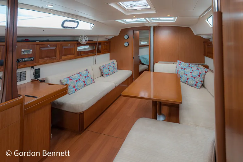 Queens Share Yacht Photos Pics Interior of 2008 Beneteau Oceanis 43 sailboat with wooden furnishings and cozy seating.