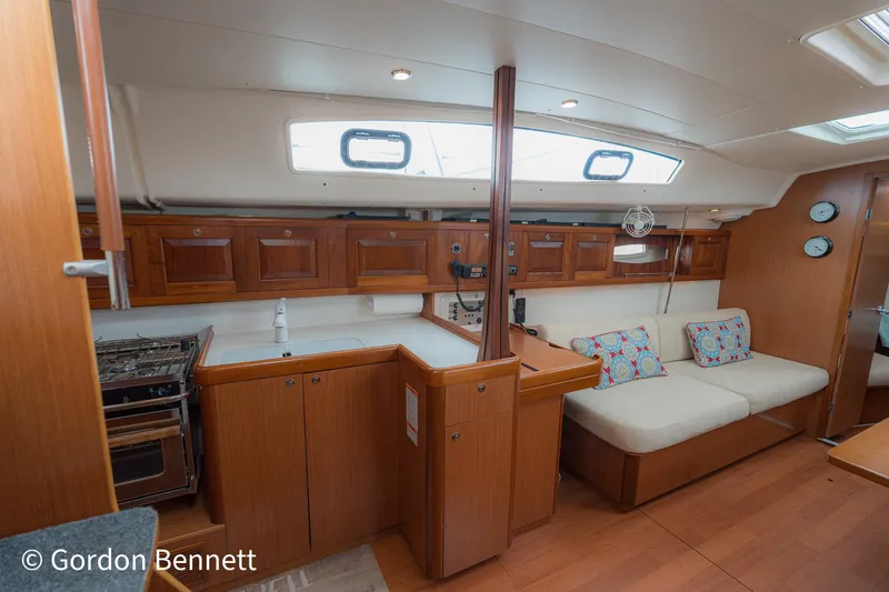 Queens Share Yacht Photos Pics Interior of 2008 Beneteau Oceanis 43 yacht with cozy seating and wooden cabinetry.