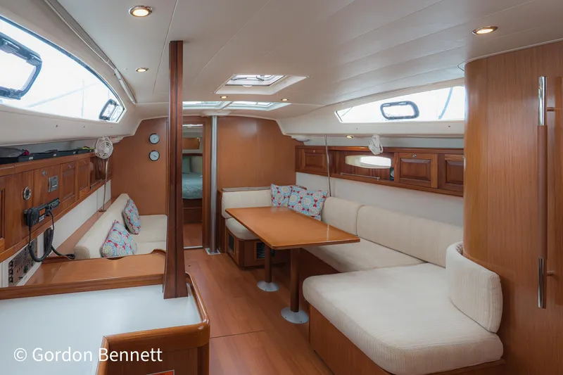 Queens Share Yacht Photos Pics Interior of 2008 Beneteau Oceanis 43 yacht, featuring cozy seating and wooden finishes.