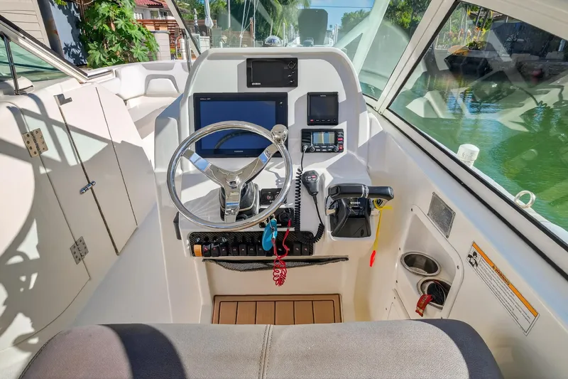  Yacht Photos Pics Cockpit of 2017 World Cat 295 DC boat with steering wheel and navigation controls.