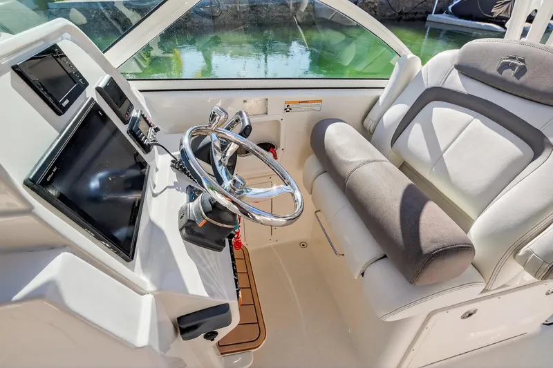  Yacht Photos Pics 2017 World Cat 295 DC boat helm with steering wheel and navigation screens.