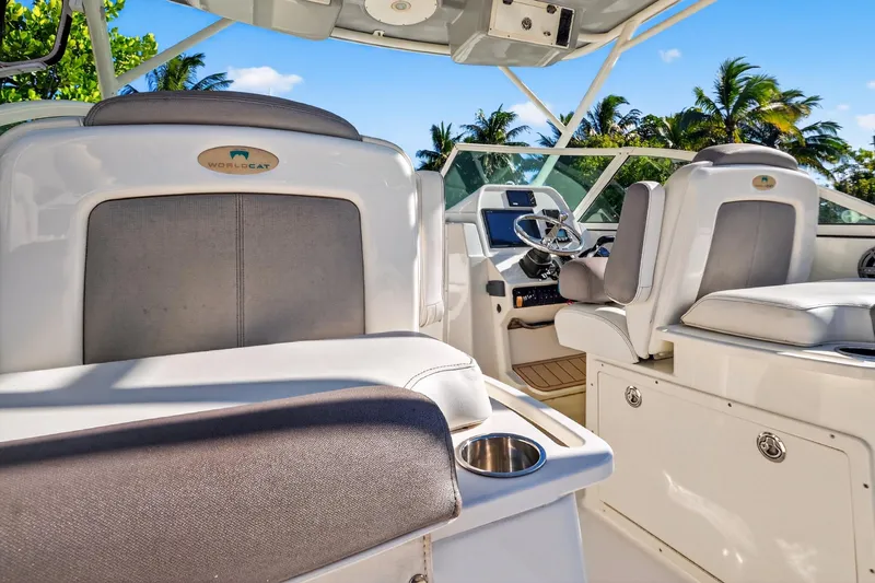  Yacht Photos Pics 2017 World Cat 295 DC boat interior with helm, seats, and tropical background.
