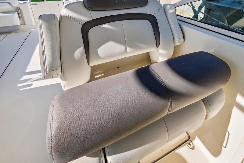  Yacht Photos Pics 2017 World Cat 295 DC boat seat with cushioned armrest in sunlight.