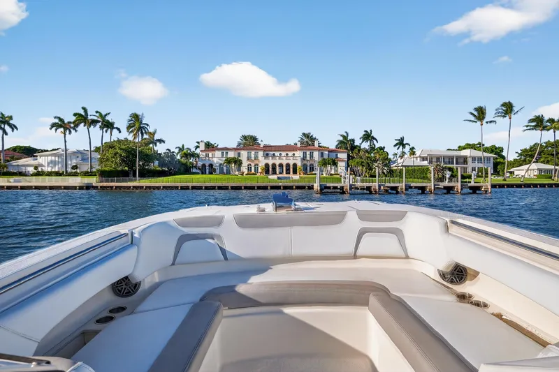  Yacht Photos Pics Front view from a 2017 World Cat 295 DC boat, overlooking waterfront mansions and palm trees.