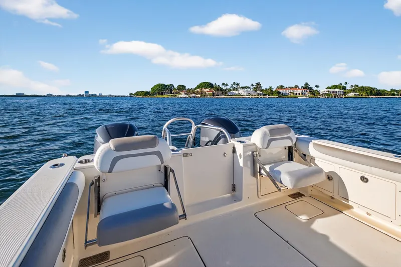  Yacht Photos Pics 2017 World Cat 295 DC boat on water, featuring spacious seating and scenic coastal view.