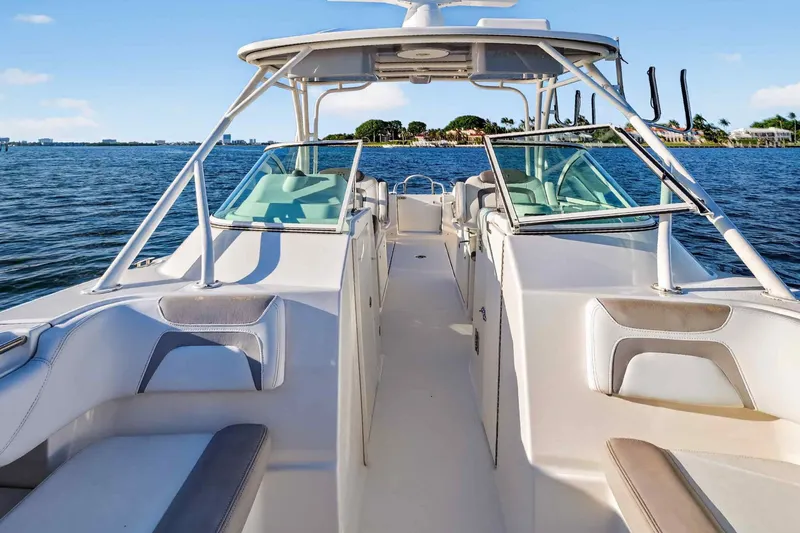 Yacht Photos Pics 2017 World Cat 295 DC boat on calm water, showcasing spacious seating and sleek design.