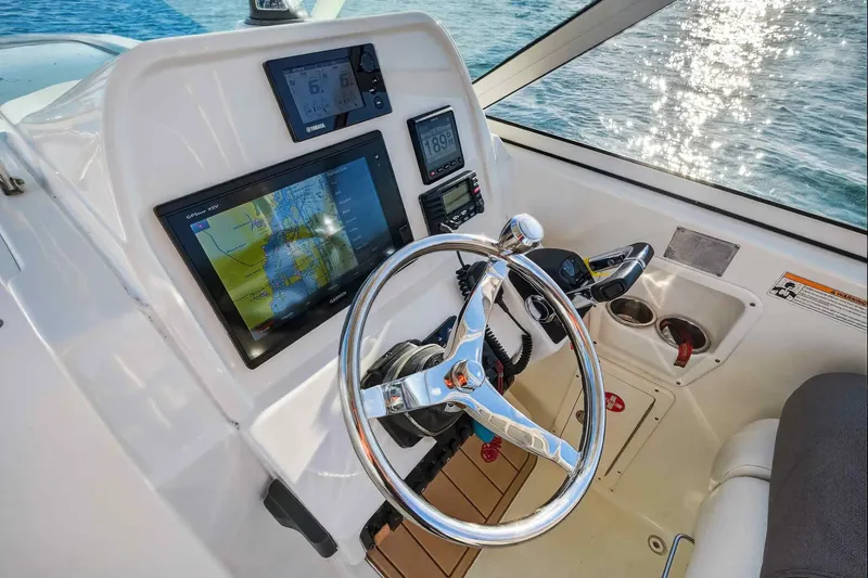  Yacht Photos Pics Helm of 2017 World Cat 295 DC boat with navigation screens and steering wheel.