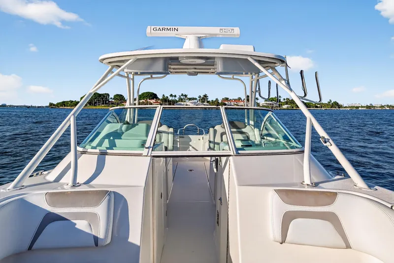  Yacht Photos Pics 2017 World Cat 295 DC boat on water, featuring Garmin radar, clear sky background.