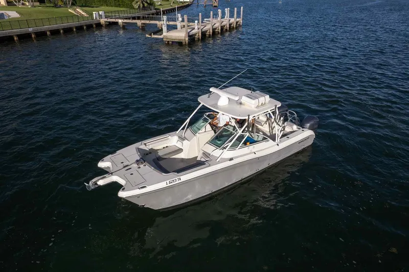  Yacht Photos Pics 2017 World Cat 295 DC boat on water near a dock, aerial view.