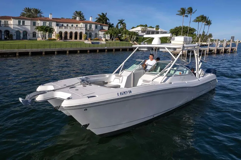  Yacht Photos Pics 2017 World Cat 295 DC boat cruising near luxury waterfront homes.