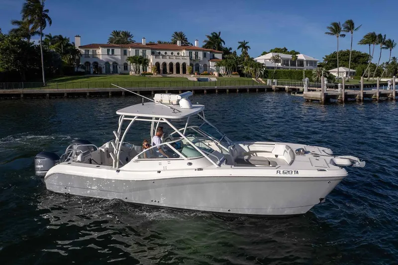  Yacht Photos Pics 2017 World Cat 295 DC boat cruising near luxury waterfront homes.