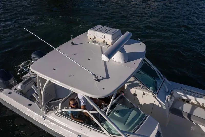  Yacht Photos Pics 2017 World Cat 295 DC boat on water, aerial view, showcasing deck and seating area.